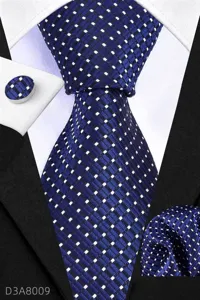 Closeup detail of the navy blue textured patterned tie, matching pocket square, and cufflink.
