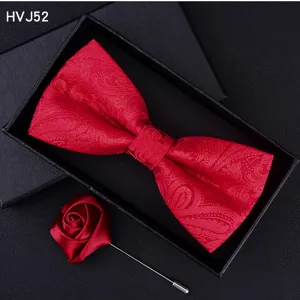 Red paisley bow tie and rose lapel pin detail shot showing texture and craftsmanship in gift box.