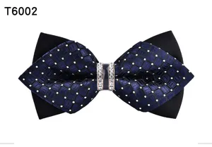 Detailed view of dark blue patterned men crystal bow tie with black base and rhinestone ring.