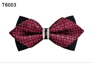 Detailed close-up of a red and black checkered men bow tie with sparkling crystal rhinestone.