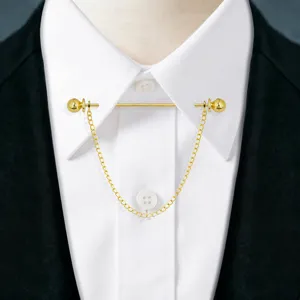 Gold metal shirt collar pin detail close up view, elegant chain tassel accessory for men