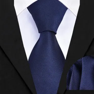 Detailed view of dark blue textured necktie and matching pocket square fabric texture.