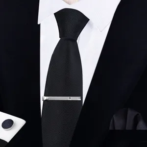 Detail view of men's black texture formal necktie set with silver tie clip and cufflinks.