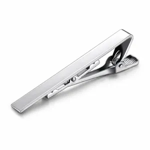 Detail view of matte silver metal tie clip clasp mechanism, polished surface craftsmanship texture