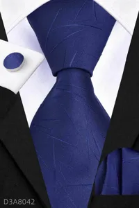Detailed view of luxury blue business mens tie set, matching pocket square and cufflinks.