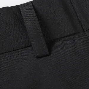 Men's black business suit trousers close-up view displaying fine waistband and belt loop.