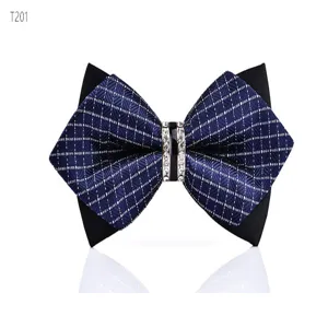 Detailed view of a navy blue grid bow tie featuring a sparkling rhinestone center buckle.