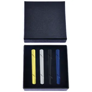 Detailed view of four color metal tie clips displayed neatly inside the elegant black gift box.