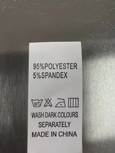 Clothing care label detail showing 95% polyester and 5% spandex material composition info.