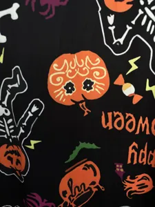 Detailed view of Halloween gothic printed fabric featuring cute pumpkins and skeletons.