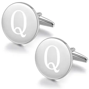 Detailed shot of round silver metal initial cufflinks with engraved letter Q for men's shirts.