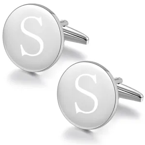 Detailed close-up view of polished silver round metal cufflinks with custom letter S engraving.