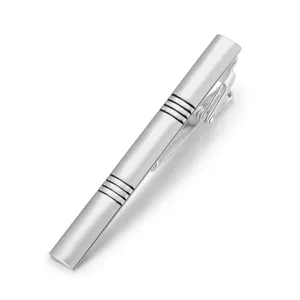 Close-up detail view of a sleek silver metallic tie clip featuring elegant striped groove patterns.