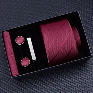Burgundy tie gift set detail showcasing necktie, cufflinks, clip, and pocket square.