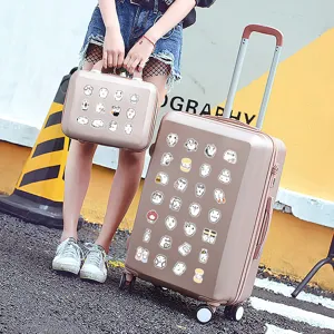 Pink travel luggage suitcase with cute cartoon puffy eyed dog stickers for travel.