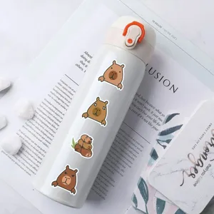 Close-up detail of a cute white thermos bottle decorated with lovely capybara stickers.