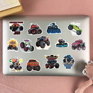 Detail shot of colorful monster truck cartoon graffiti stickers displayed neatly on a laptop.