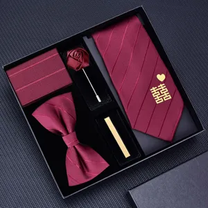 Burgundy wedding tie set detail view, featuring pre-tied necktie, bow tie, and matching pocket square.
