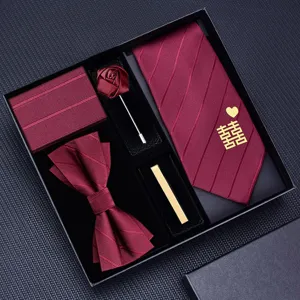 Burgundy mens wedding tie set featuring elegant bow tie pocket square brooch and tie clip details.
