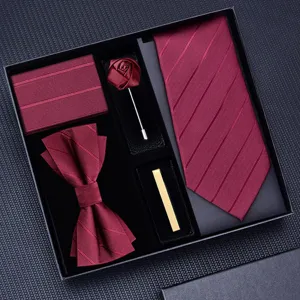 Detailed view of the burgundy tie set box showing textured tie, bow tie, and matching pocket square.