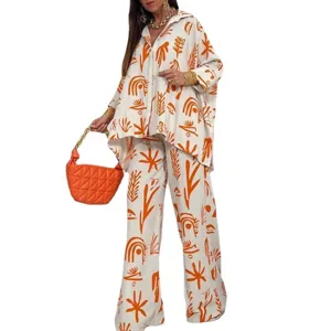 Casual oversized tweedelig set met losse knopenhemd en rechte broek met abstracte print.