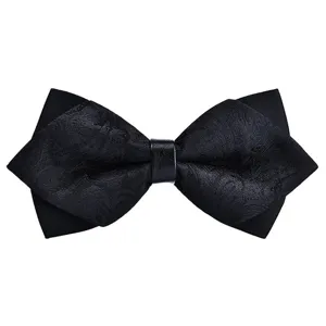 Black men's pointed bow tie detail view, elegant paisley jacquard fabric design.