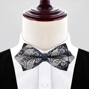 Men's diamond-shaped paisley bow tie for wedding suit, elegant blue and gold groom accessory.