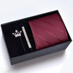 Men's burgundy striped tie gift set with silver crown brooch and tie clip in a black box.