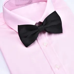 Elegant black silk bow tie paired with a classic pink dress shirt for men's formal wear.