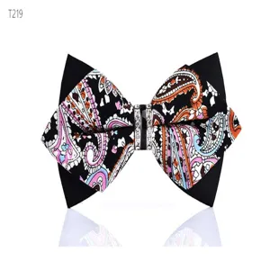 Detail shot of a stylish men's bow tie with paisley print and crystal rhinestone buckle.