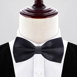 Black double-layer formal bow tie close-up detail, smooth fabric texture and neat collar.