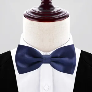 Detailed view of dark blue double layer formal bow tie on white shirt collar for men.