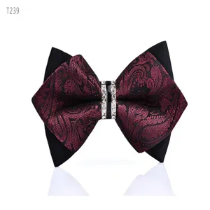 Detailed view of the elegant rhinestone bow tie with classic paisley pattern and black fabric.
