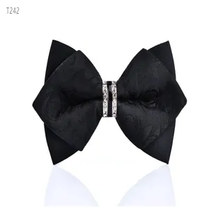 Close-up detail of black double-layer sharp bow tie with crystal rhinestone center ring.
