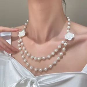 Elegant double layer faux pearl choker necklace with chic white flower pendants for women.