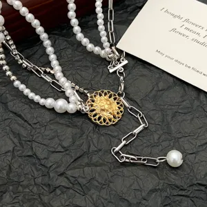 Detailed shot of a multi-layer layered pearl choker necklace with retro gold metal pendant.