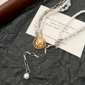 Vintage gothic layered pearl choker necklace with gold pendant and tassel chic.