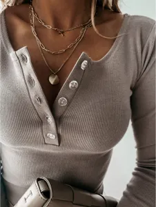 Ribbed knit long sleeve top detail featuring chic henley buttons and soft textured fabric.