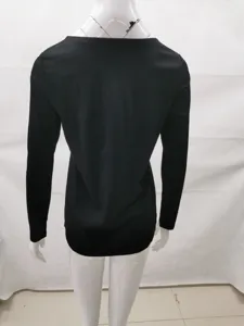 Back view of a plain black slim-fit long-sleeve women top displayed on a mannequin.