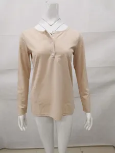 Detail view of women solid color ribbed long sleeve top with button placket design.