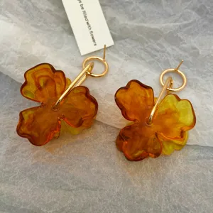 Chic Maillard style amber resin petal earrings with gold tone metal rings for women.