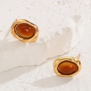 Elegant gold textured oval stud earrings with brown amber stone for daily chic outfit.