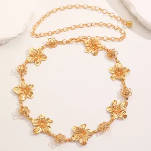 Gold metal flower waist chain, boho beach dress accessory, delicate floral design detail.