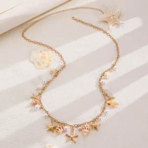 Gold metal waist chain featuring seashell, starfish and pearl charms, beach jewelry detail.
