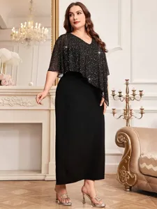 Detail shot of the elegant plus-size black evening dress featuring a sparkly batwing overlay.