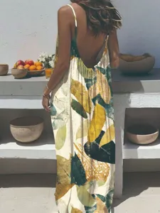 Detail shot of a bohemian botanical leaf print sleeveless strap long dress in a rustic scene.