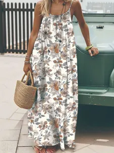 Detail view of floral print sleeveless maxi dress in bohemian summer style outdoors.