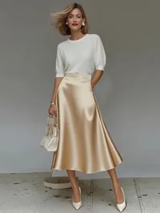Elegant white knit top and champagne satin midi skirt set, perfect for professional women.