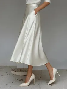 Detail view of elegant white satin A-line midi skirt, smooth fabric texture for women fashion.
