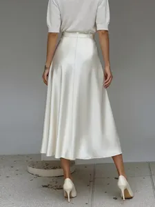 Detail view of elegant women's glossy satin A-line midi skirt, smooth fabric texture.